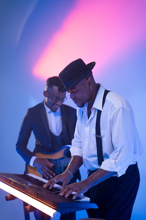 Two Men Enjoying While Playing Musical Instruments