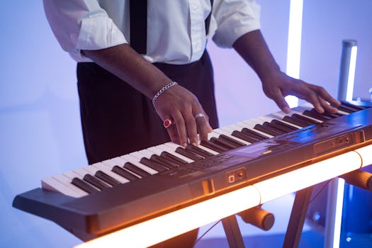 A musician skillfully plays a keyboard instrument under vibrant lights.