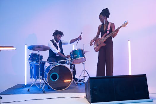 Energetic band performance with drummer and bassist on stage.