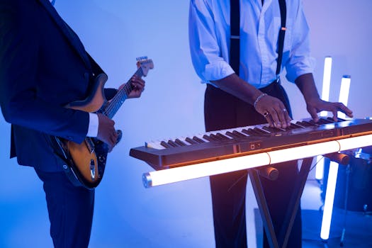 Dynamic scene of musicians playing guitar and keyboard in a vibrant studio setting.
