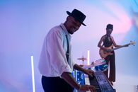 Man Playing an Electric Piano Beside a Woman Playing Electric Guitar