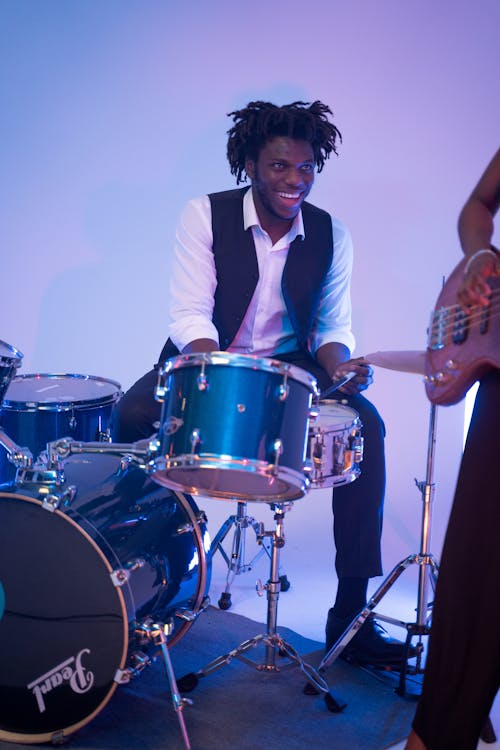 Man in White Dress Shirt Playing the Drums