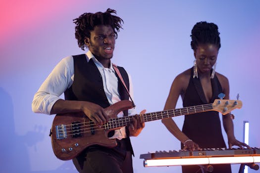 Dynamic duo performing on bass guitar and electric piano in a vibrant setting.
