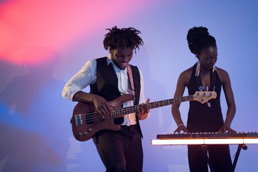 Two musicians performing passionately in a vibrant studio setting with bass guitar and keyboard.