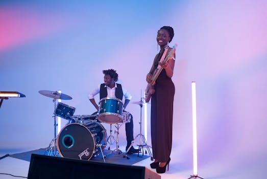 Captivating indoor music performance featuring a drummer and a guitarist in a colorful setting.