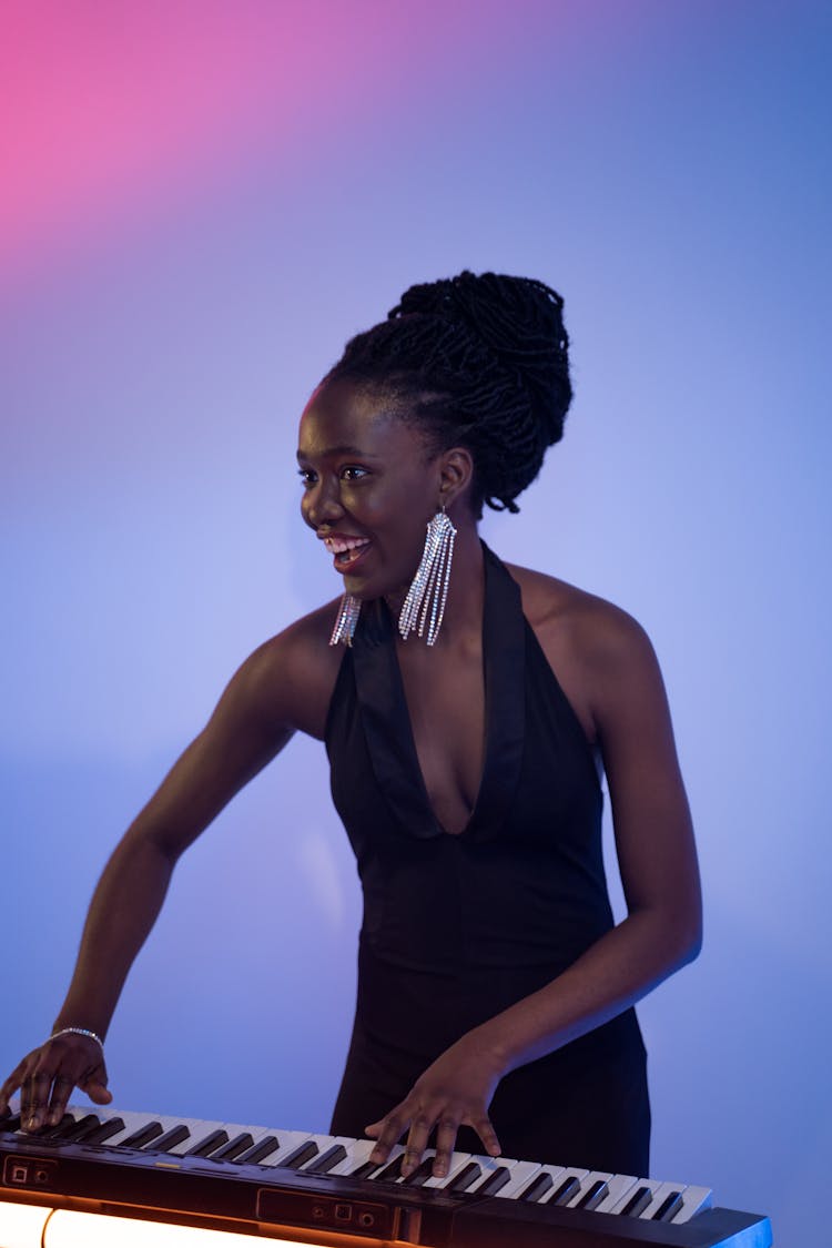 Woman In Black Dress Playing Keyboard