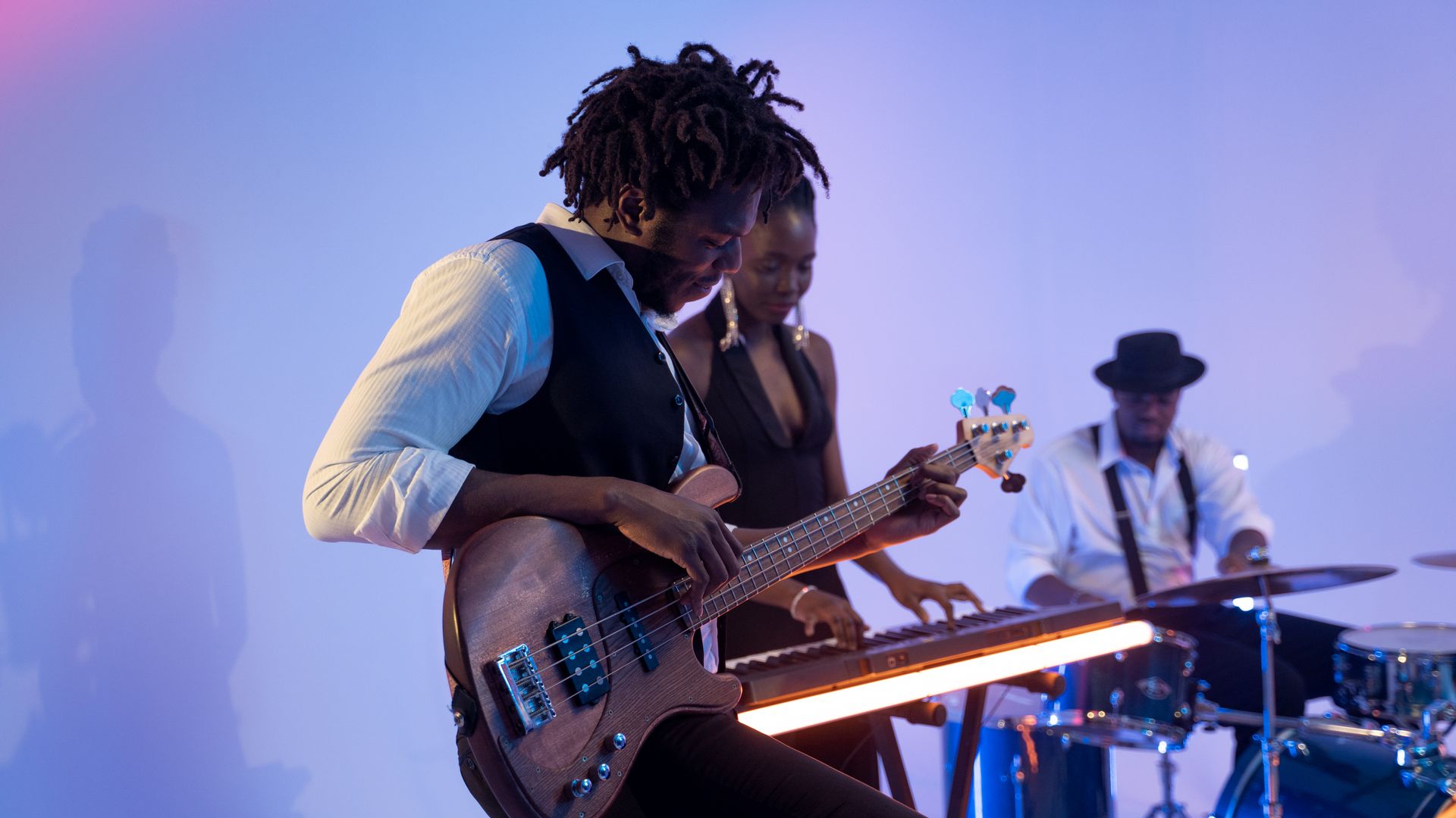Modafinil for Musicians on Tour: Unleash Creativity Musicians performing together with guitar, keyboard, and drums under colorful lighting — modafinil for musicians on tour