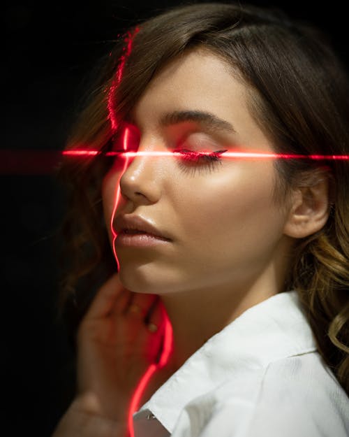 Tender ethnic model with closed eyes in laser beams