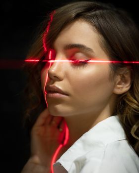 Tender ethnic model with closed eyes in laser beams