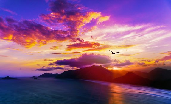 Stunning sunset view over the Rio de Janeiro coastline with vibrant skies and distant mountains.