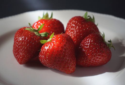 Delicious ripe strawberries on a plate, perfect for healthy eating and nutrition.