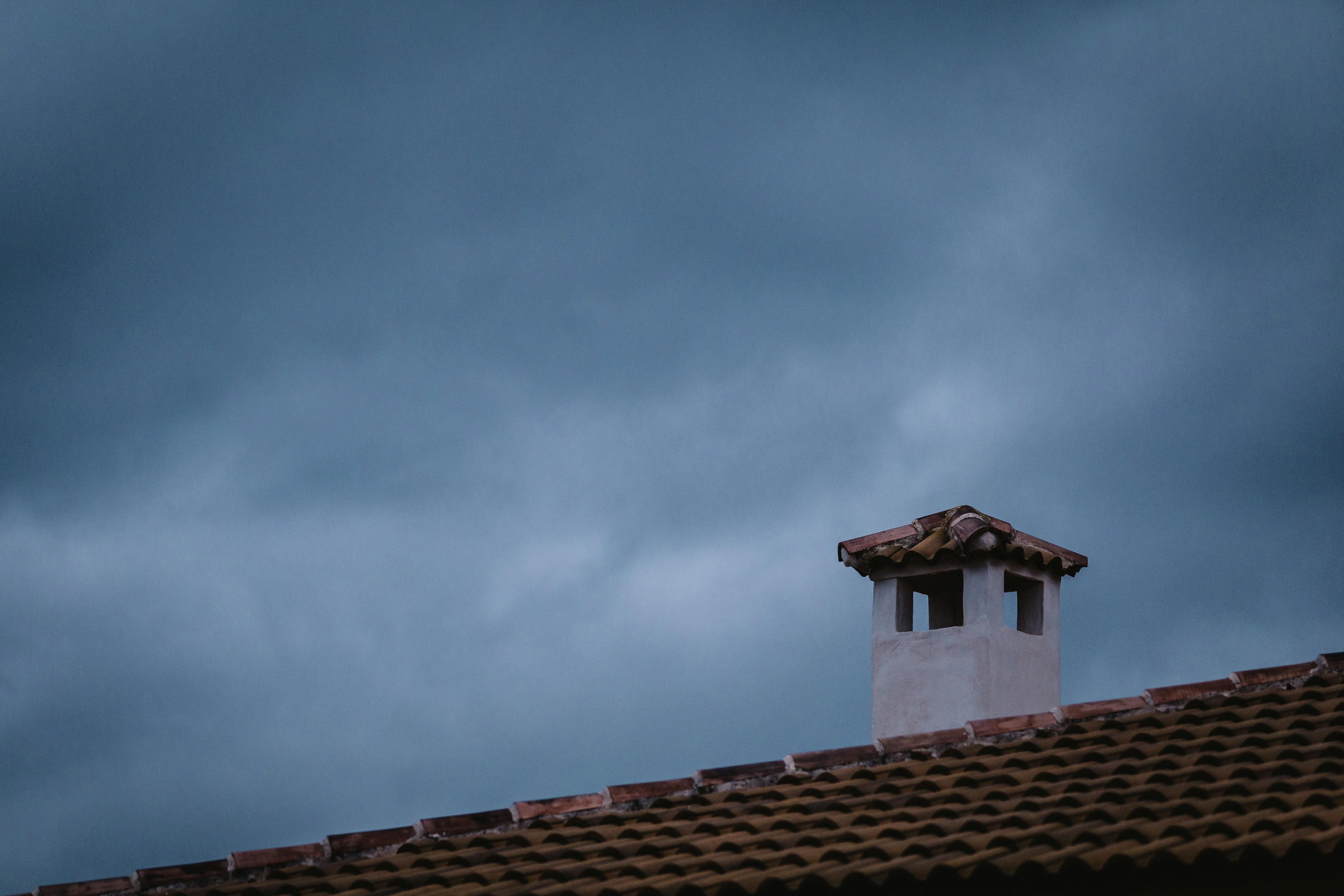 White and brown concrete chimney installed on the roof of a house in Connecticut