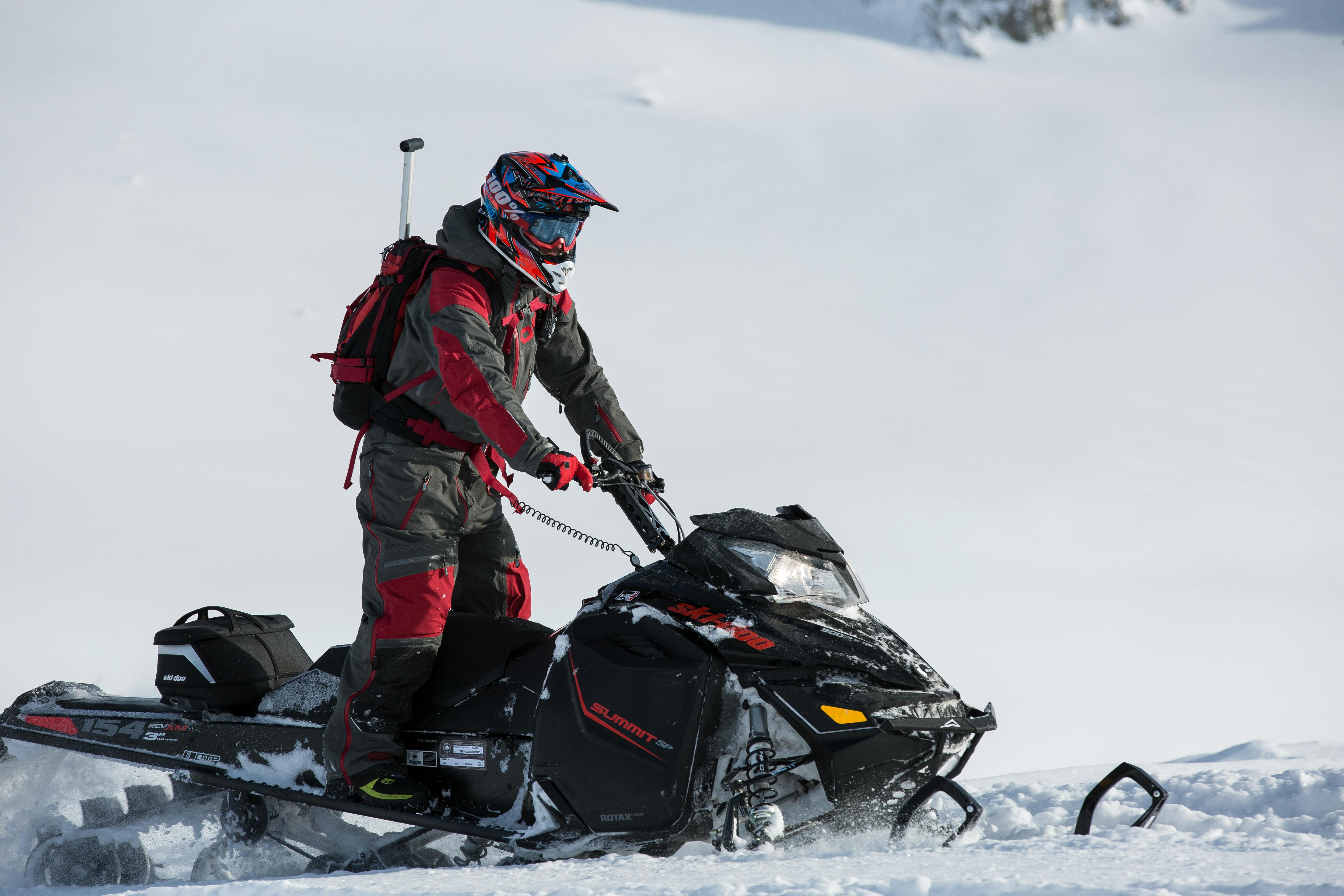 person riding on snowmobile