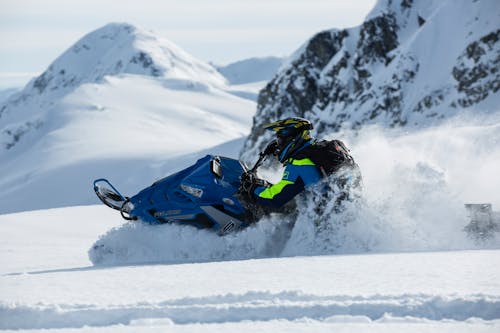 Free Person Riding on Snowmobile Stock Photo
