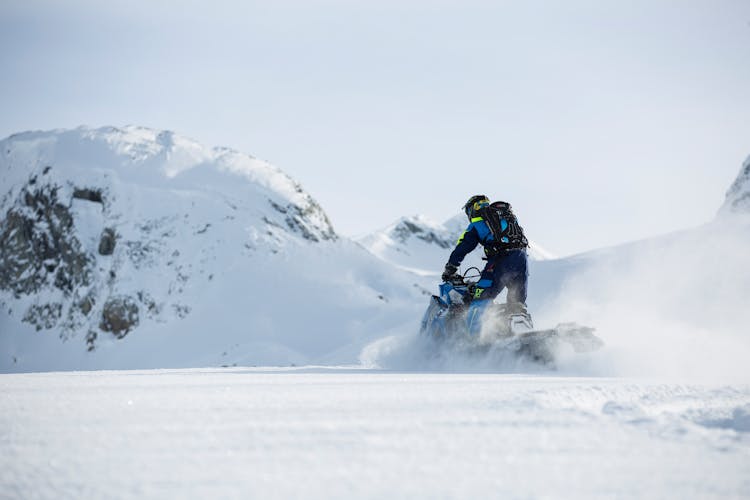 Person Riding On Snowmobile During Winter