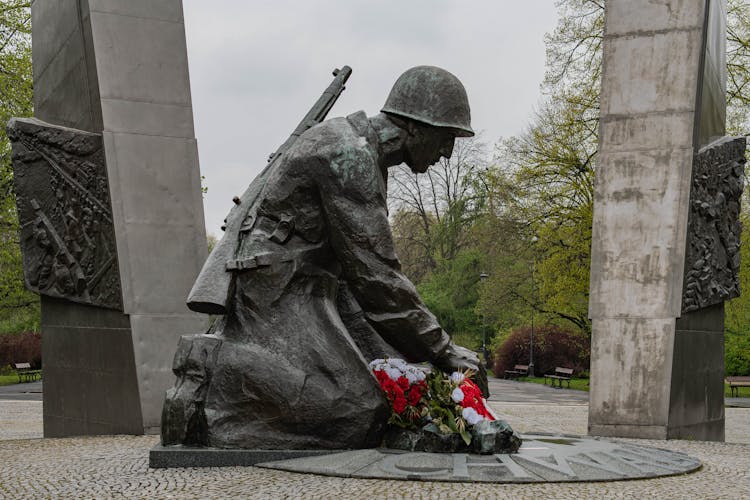 A Statue Of A Soldier Kneeling