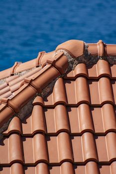 Close-up of a classic red tiled roof in Dubrovnik against the backdrop of the blue Adriatic Sea.