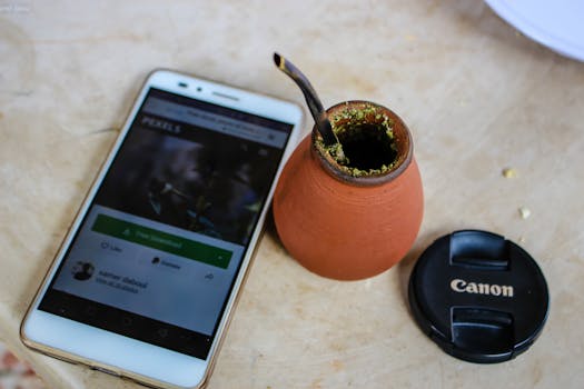 White Android Smartphone Beside Brown Ceramic Pot