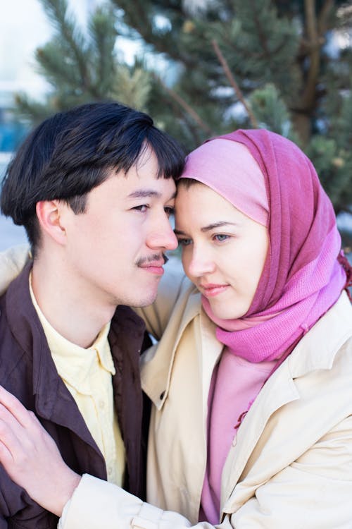 Free A Woman in Pink Hijab Embracing a Man Stock Photo