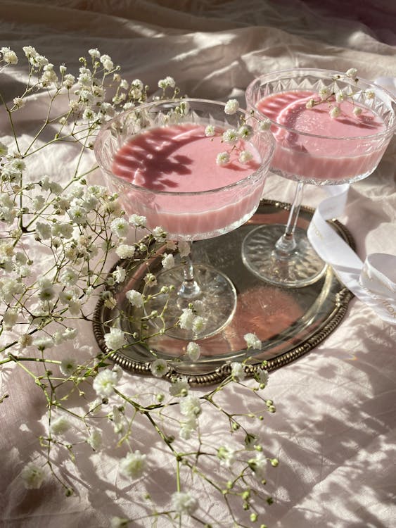 A Pair of Coupe Glasses with Baby's Breath Flowers on a Silver Tray