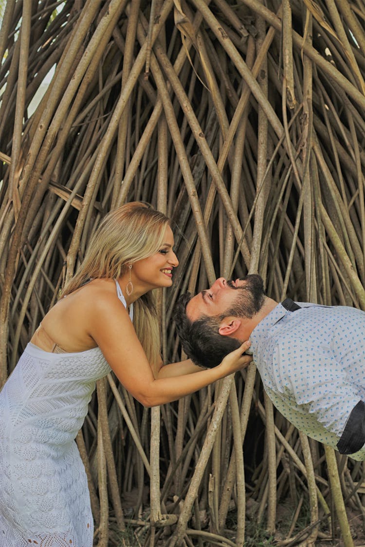 A Woman Holding A Man's Neck