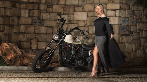 Free Woman In Black and Grey Long-sleeved Dress Standing Beside Cruiser Motorcycle Stock Photo
