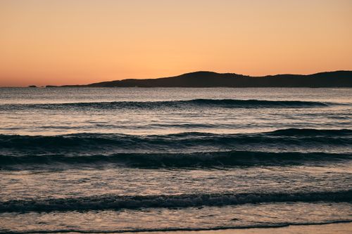 Free Peaceful sunrise over the ocean with gentle waves along New South Wales, Australia coast. Stock Photo