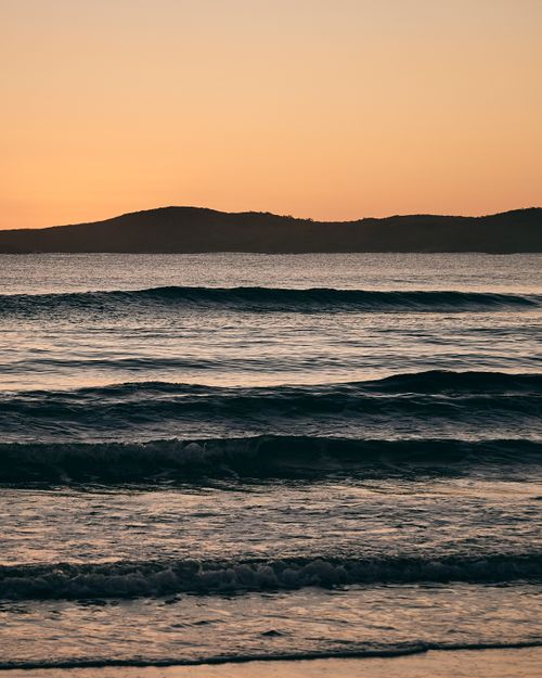 Free Tranquil seascape capturing ocean waves at sunset on the NSW coast, highlighting natural beauty. Stock Photo