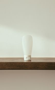 Simple and elegant squeeze bottle on a wooden shelf, perfect for product mockup or design inspiration.