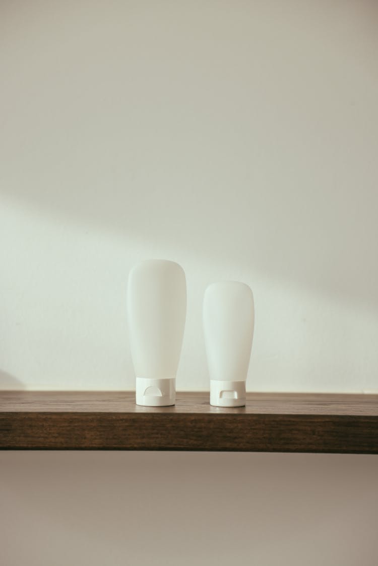 White Plastic Bottles On The Wooden Surface