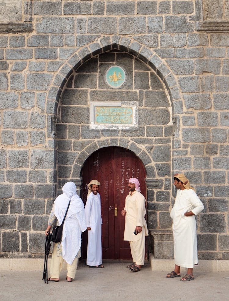 People Standing Outside The Abu Bakr Mosque