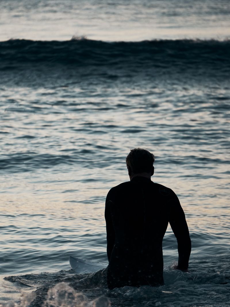 A swimmer standing chest deep in open water — Gilberto Olimpio on Pexels