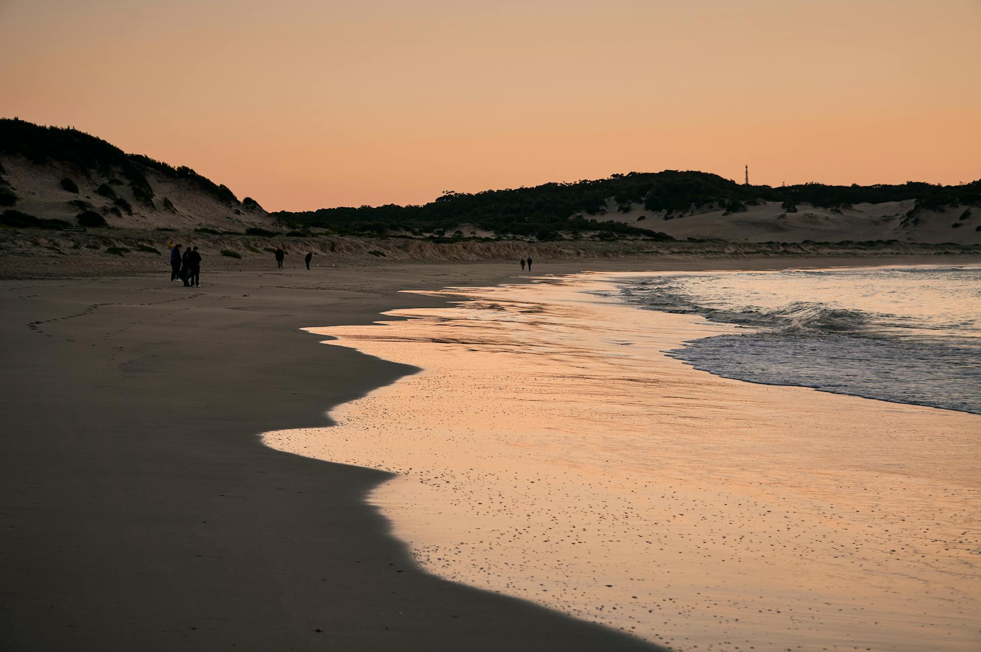 Peaceful twilight on the shores of One Mile Beach in New South Wales, Australia.