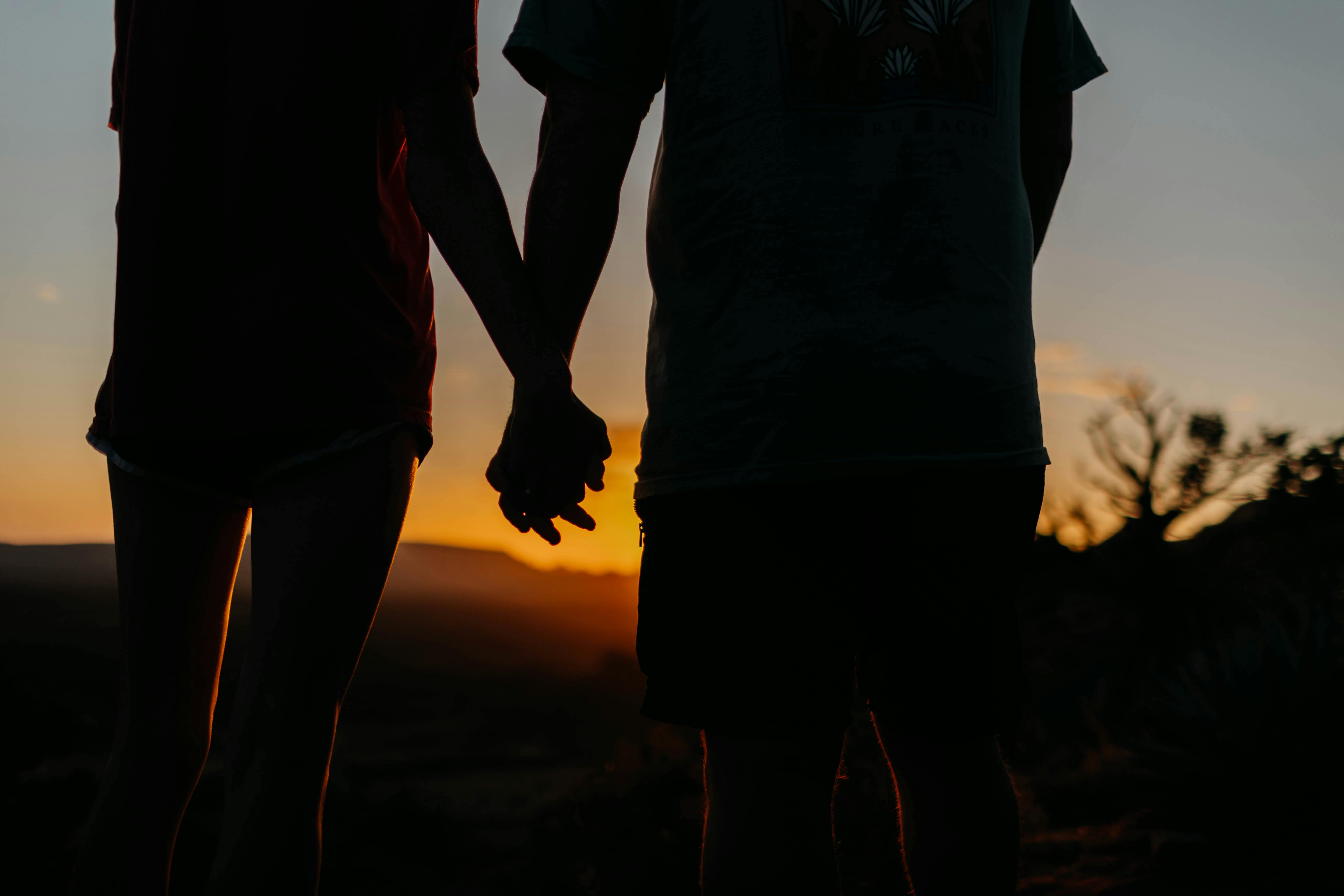 silhouette couple holding hands