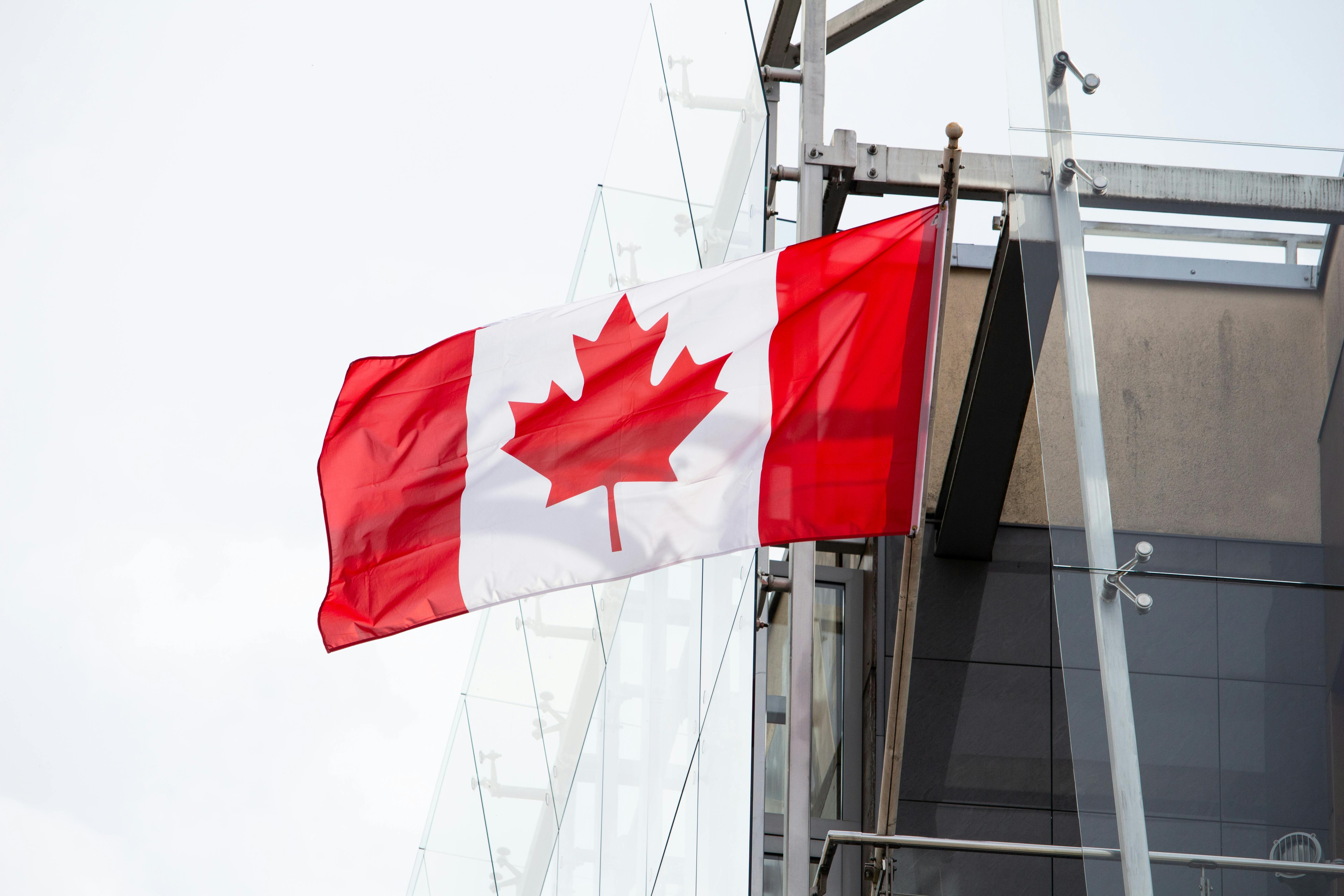 Photo of the Canada Flag Beside a Building