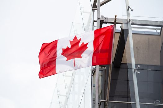 A vibrant Canadian flag waving on a clear day, representing patriotism and national pride.