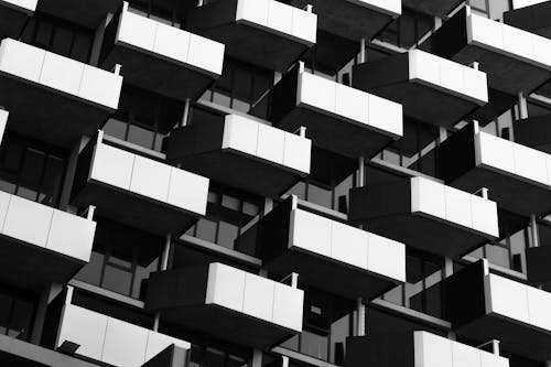 Grayscale Photo of Apartment Balconies