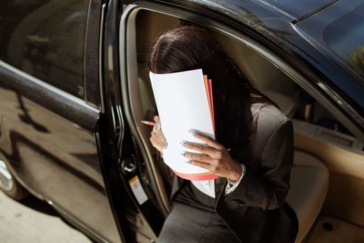 Woman in Black Blazer Holding White Printer Paper