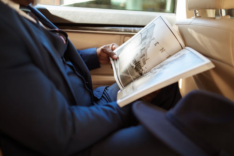 Person In Blue Suit Holding A Book