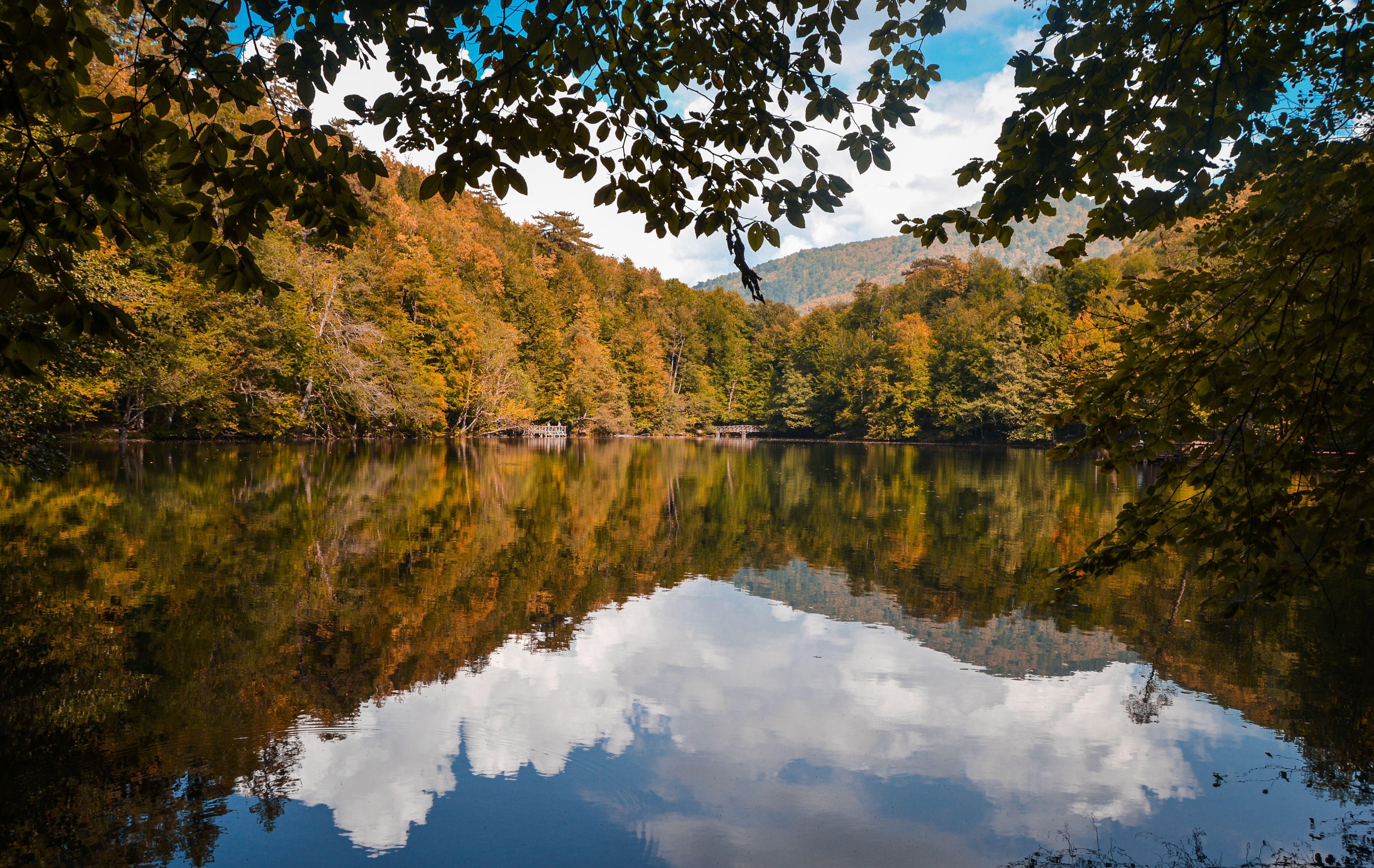 Reflective lake surrounded by vibrant autumn foliage in Bolu, Turkey, perfect for nature enthusiasts.