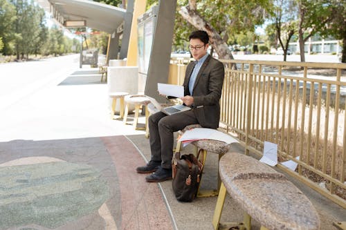 Free Man in Black Suit Sitting on Concrete Chair Stock Photo