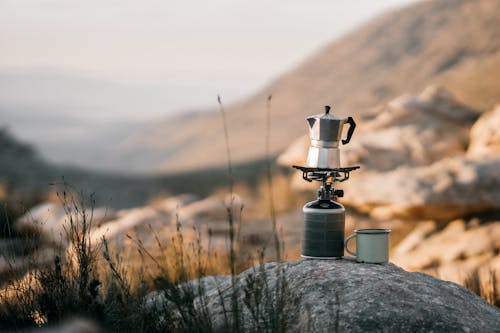 Gray and Black Metal Candle Lantern on Gray Rock