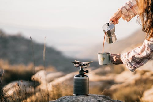 Free Person Pouring Coffee on a Cup Stock Photo