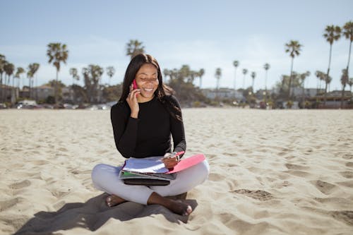 Free Woman on the Beach Talking on the Phone Stock Photo
