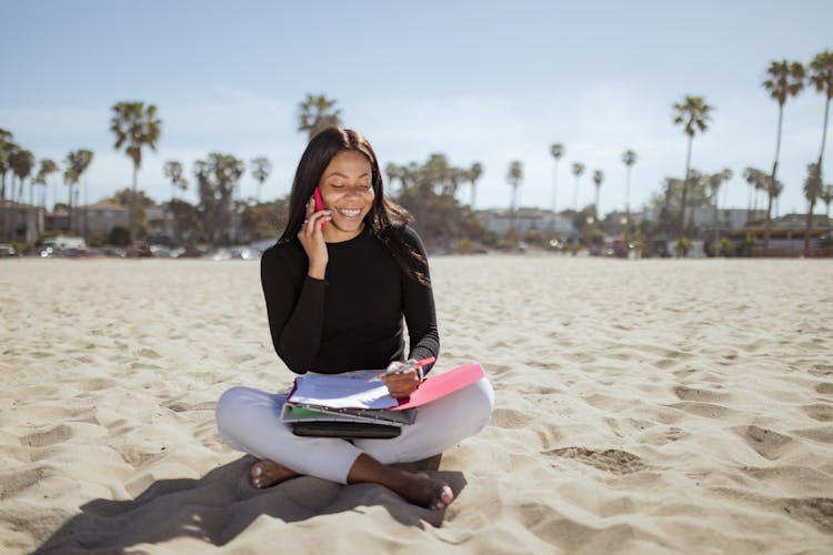 Woman On The Beach Talking On The Phone