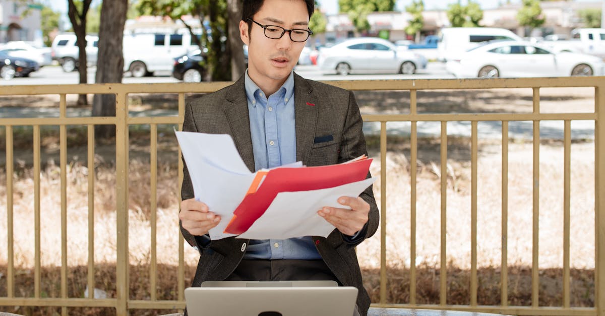 A diverse group of people sitting around a conference table, discussing paperwork and immigration options.