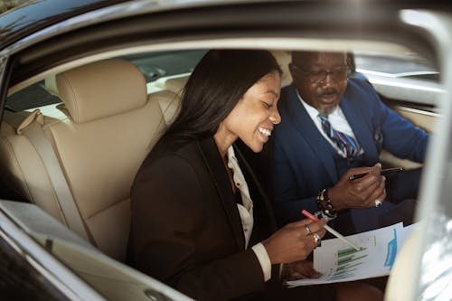 Woman and Man Having a Business Discussion in a Car 