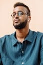 Man in Blue Button Up Shirt Wearing Black Framed Eyeglasses