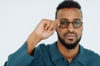 Man in Blue Dress Shirt Wearing Black Framed Eyeglasses