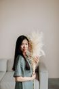 Pretty Woman Holding a Pampas Grass